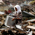 Woman searches through wreckage in the aftermath of Indian Ocean tsunami Woman searches through wreckage in the aftermath of Indian Ocean tsunami