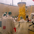 Workers monitoring radioactive waste tank Workers monitoring radioactive waste tank