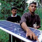 Men with solar panels in Sri Lanka Men with solar panels in Sri Lanka